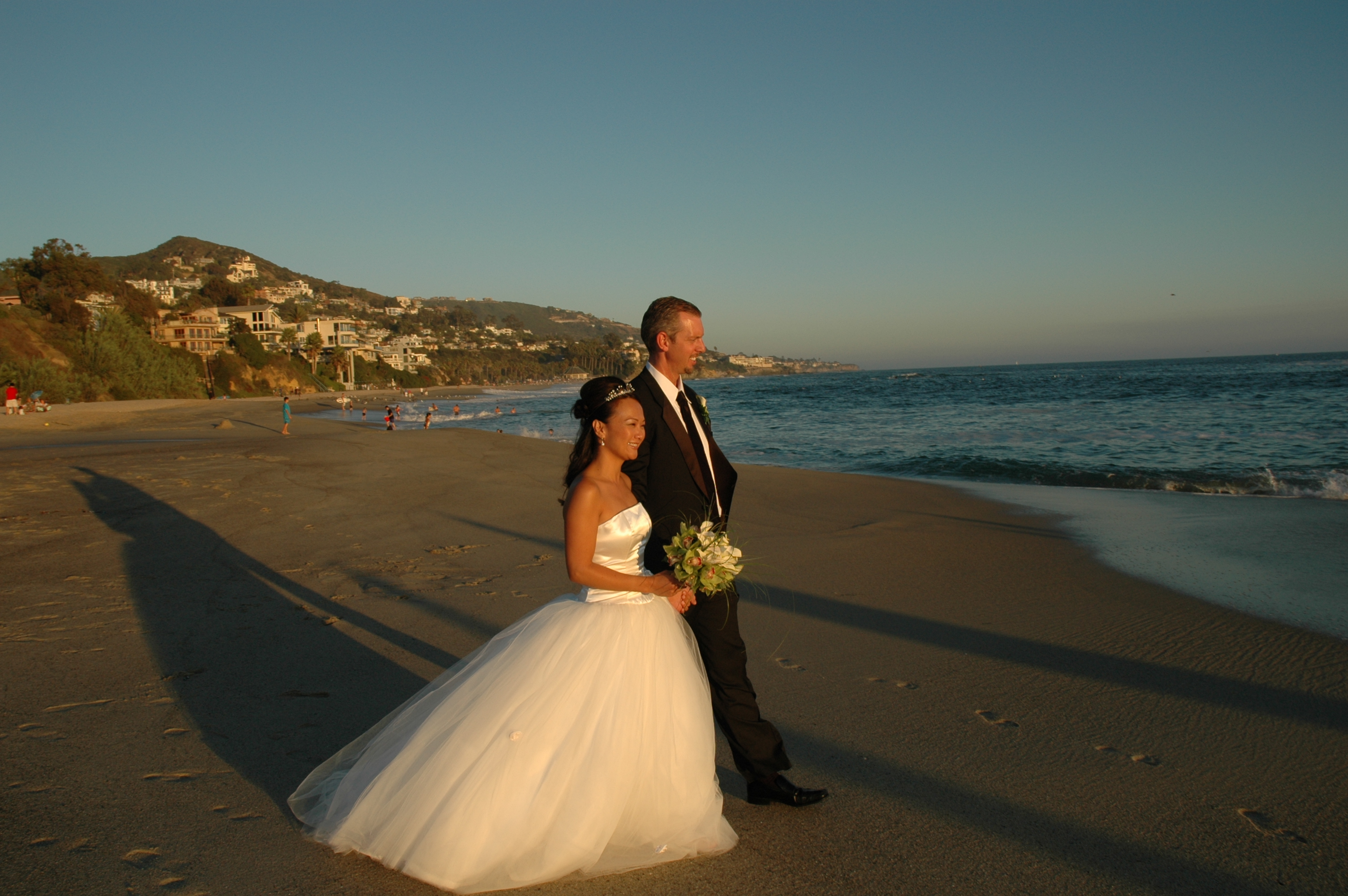Sean and Tami walking on the beach at sunset