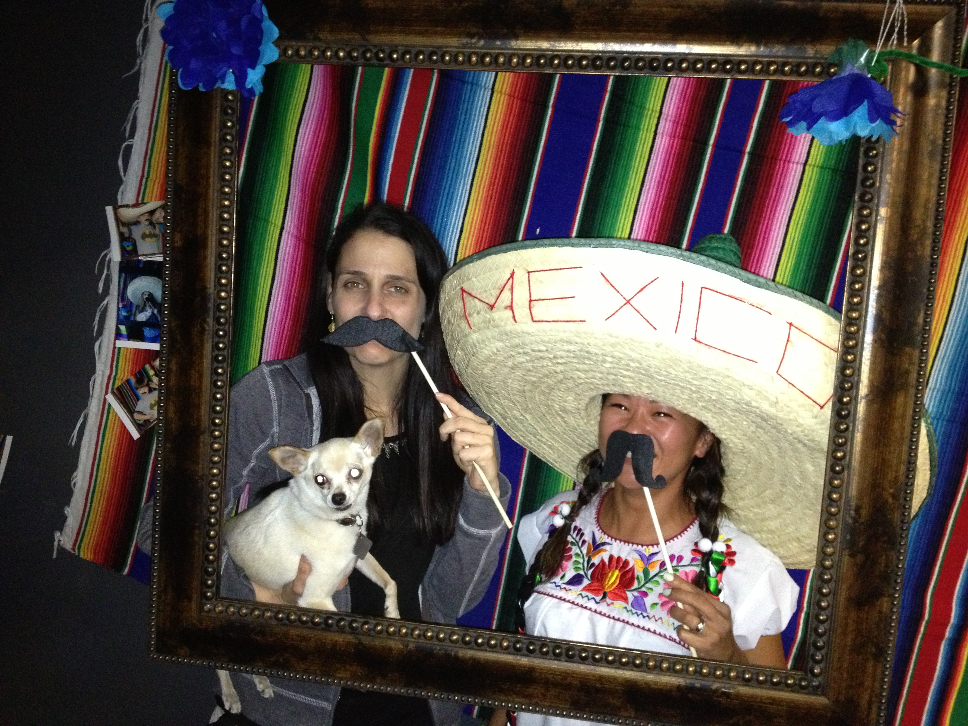 Friends with a "Mexico" sombrero and a dog