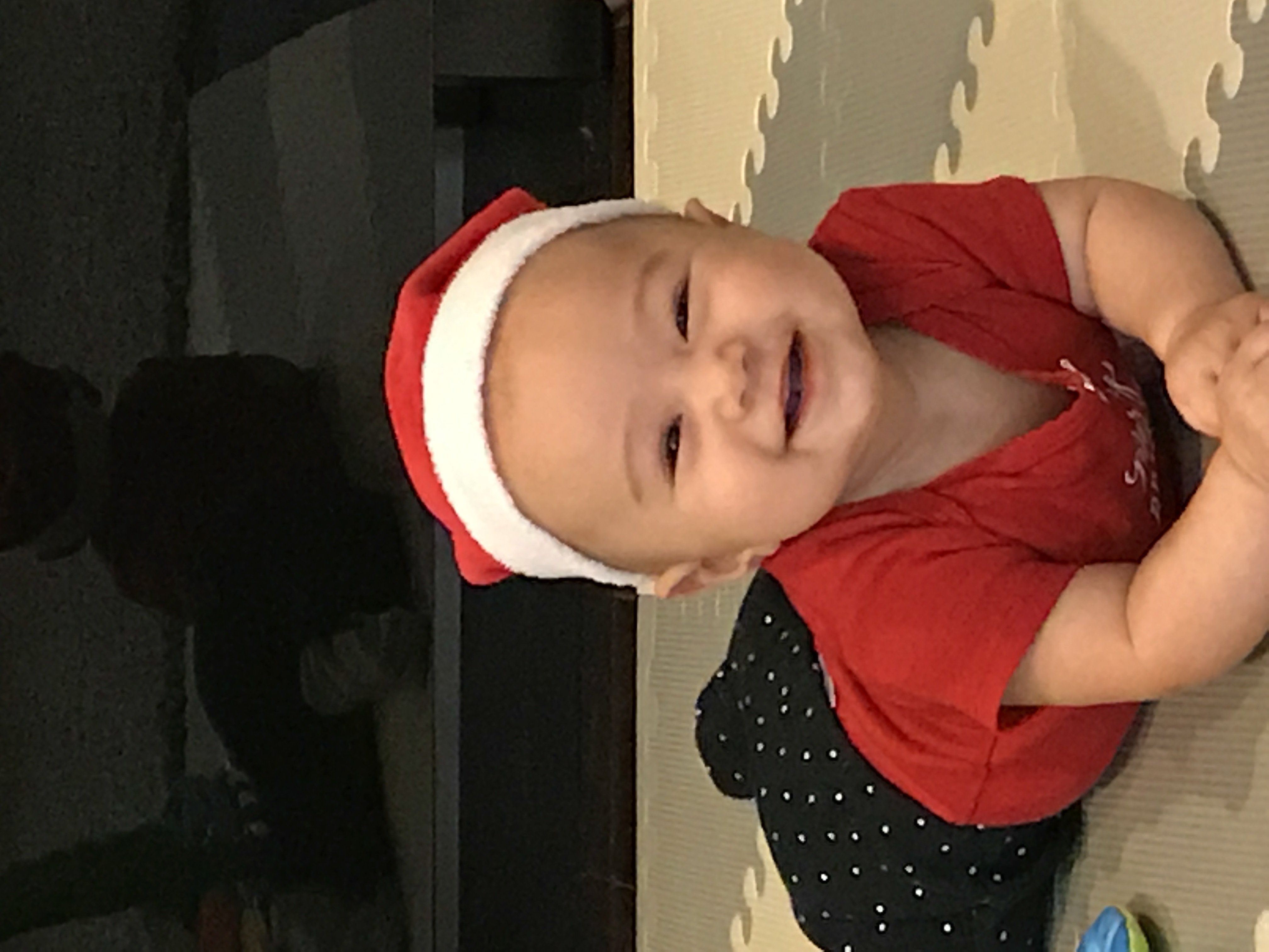 Chloe smiling in a Santa hat, Christmas 2016