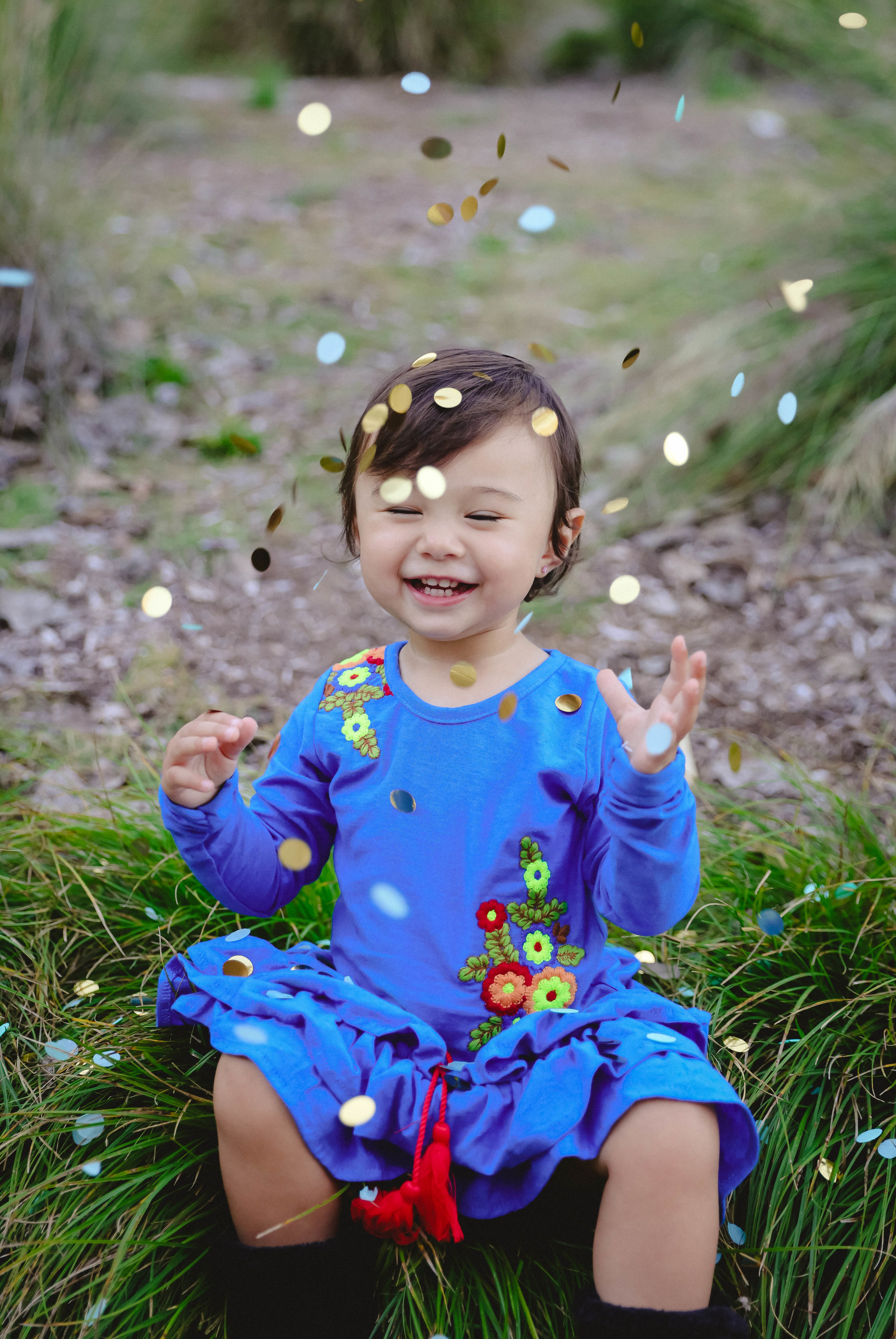 Chloe playing with confetti