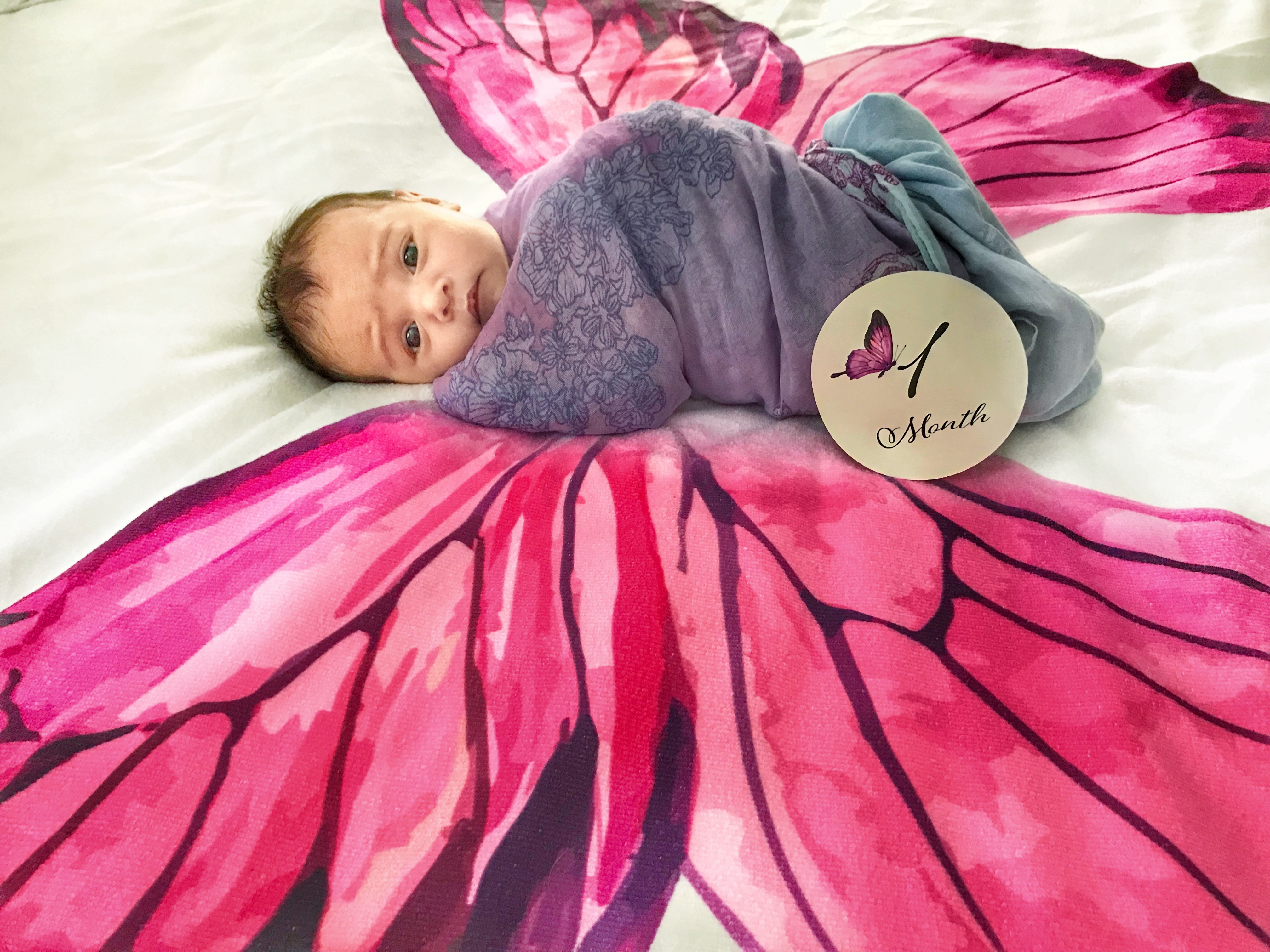 Riley at one month, wrapped in a butterfly wing swaddle