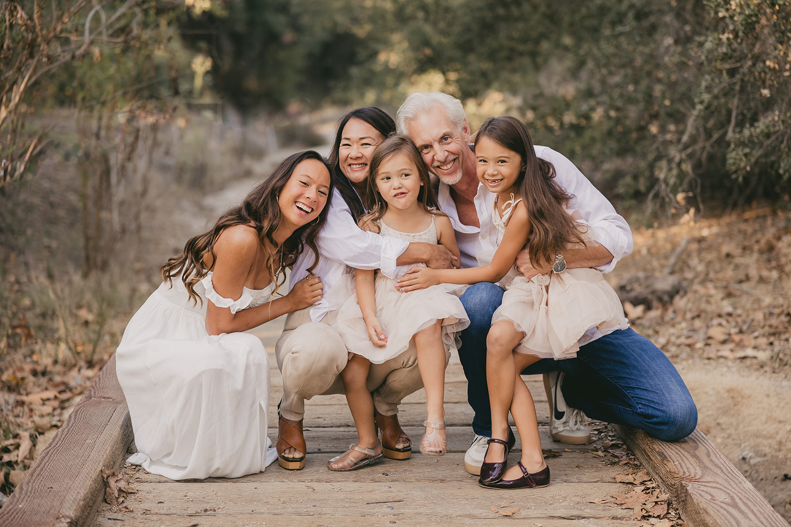 The family in a group hug on the bridge