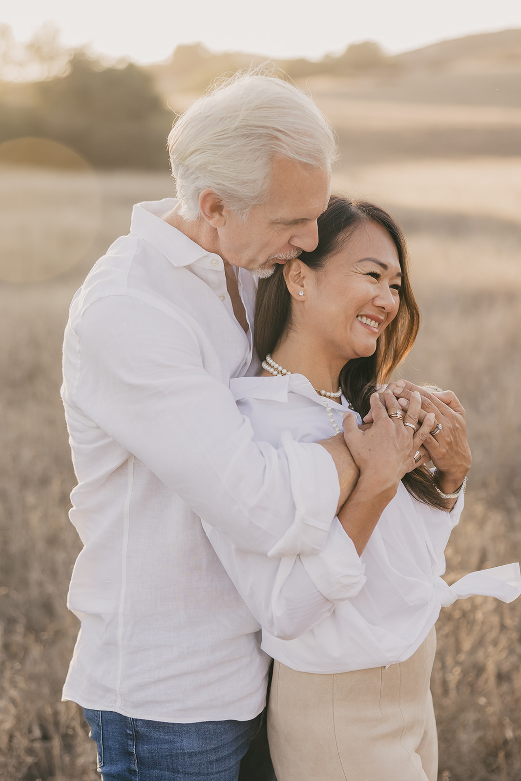 Sean and Tami embracing in a golden field
