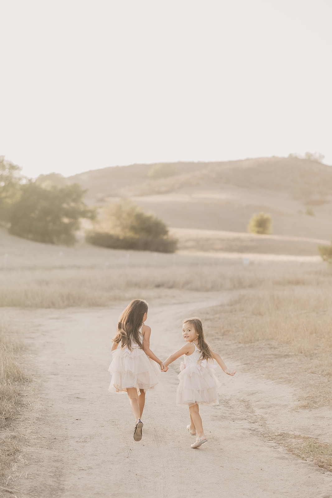 Chloe and Riley holding hands, walking